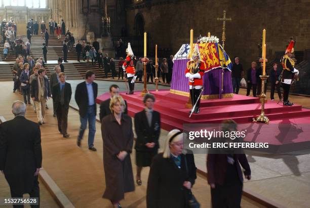 Mourners pass by the coffin of Queen Mother as it lays in-state 05 April 2002, in Westminster Hall. Queen Mother will lay in Westminster Hall until...