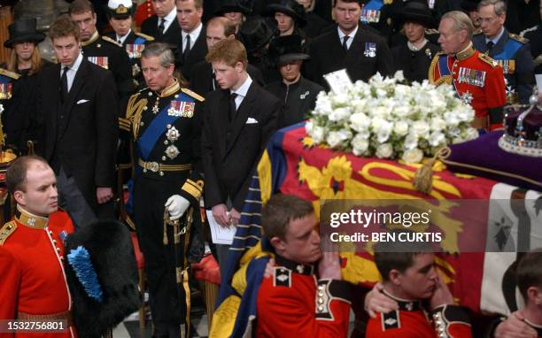 Prince William , his father, the Prince of Wales, and brother, Prince Harry, stand as the coffin of Queen Elizabeth the Queen Mother is carried from...