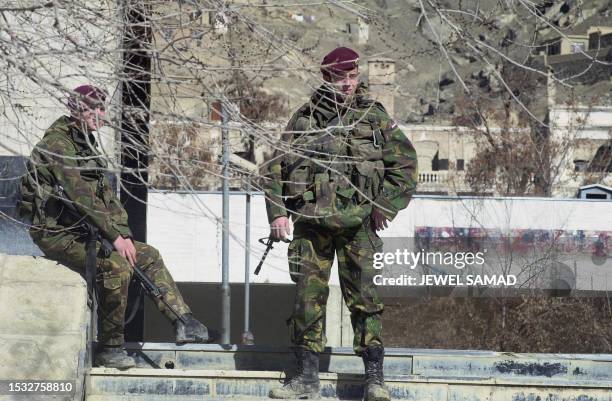 Austrian members of the International Security Assistance Force keep vigil at Kabul University where hundreds of students, including female students,...