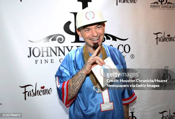 Rapper Paul Wall poses for a photo at the grand opening of his grillz store, Johnny Dang & Co., Saturday, Oct. 22 in Houston.