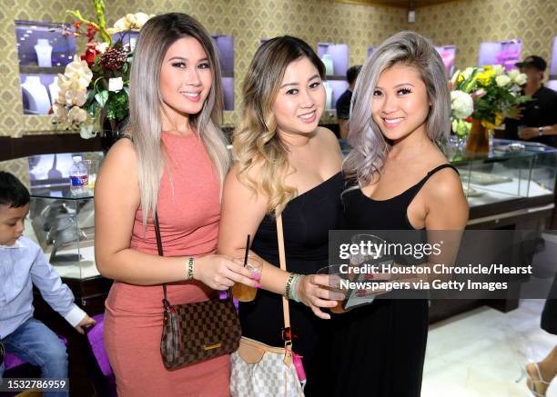 Participants pose for a photo at the grand opening Paul Wall's grillz store, Johnny Dang & Co., Saturday, Oct. 22 in Houston.