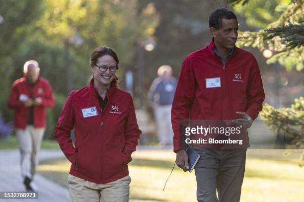 Mark Edwards, co-founder and chief executive officer of Upstream USA, right, and Janet Rich-Edwards walk to the morning session during the Allen &...
