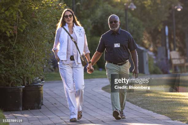 Ian Rowe, founder and chief executive officer of Vertex Partnership Academies, right, and Sylvia Rowe walk to the morning session during the Allen &...