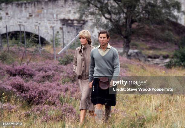 Prince Charles with his arm around his wife Princess Diana during a honeymoon photocall by the River Dee at the Balmoral Estate, Scotland on 19th...