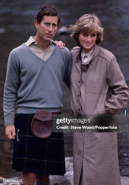 Prince Charles with his arm around his wife Princess Diana during a honeymoon photocall by the River Dee at the Balmoral Estate, Scotland on 19th...