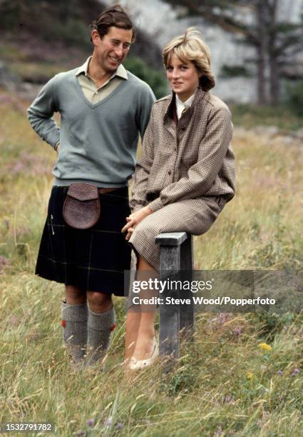 Prince Charles with his arm around his wife Princess Diana during a honeymoon photocall by the River Dee at the Balmoral Estate, Scotland on 19th...