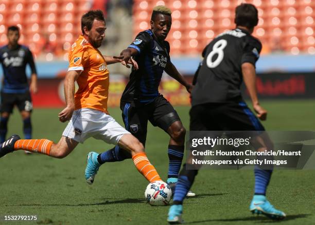 Houston Dynamo midfielder Eric Alexander dribbles while San Jose Earthquakes players defensing during the first half of the game at BBVA Compass...