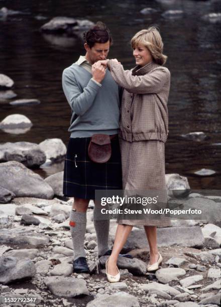 Prince Charles with his arm around his wife Princess Diana during a honeymoon photocall by the River Dee at the Balmoral Estate, Scotland on 19th...