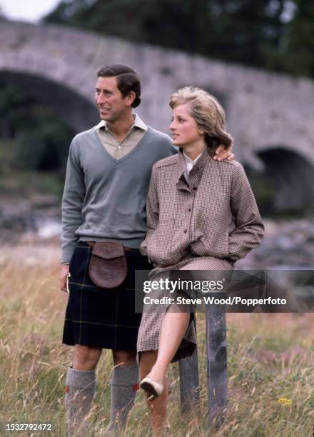 Prince Charles with his arm around his wife Princess Diana during a honeymoon photocall by the River Dee at the Balmoral Estate, Scotland on 19th...