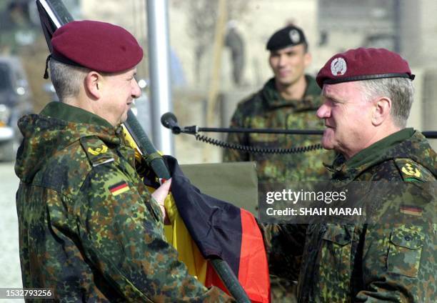 Incoming International Security Assistance Force commander, German General Werner Freers , receives the German flag from the commander of German Army...