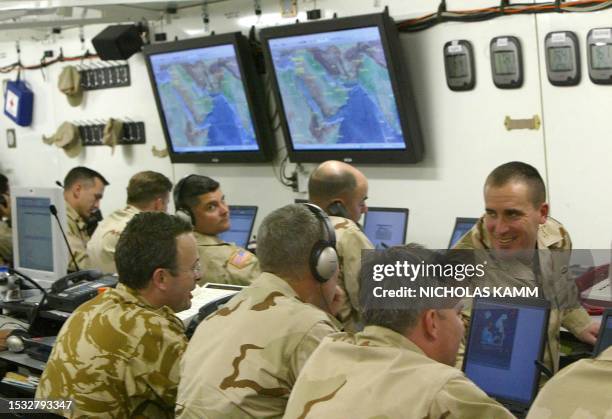 And British soldiers chat in the Joint Operations Center at the As-Sayliyah base, 15km south of Doha, during the Internal Look military exercise 12...