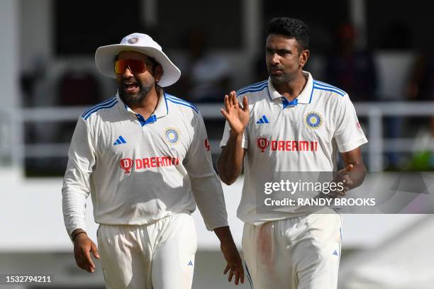 Rohit Sharma and Ravichandran Ashwin , of India, celebrate the dismissal of Alick Athanaze, of West Indies, during day three of the First Test...