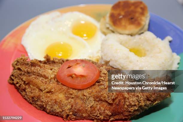 The Breakfast Klub's signature katfish & grits plate is photographed at George Bush Intercontinental Airport Terminal A North Thursday, April 20 in...