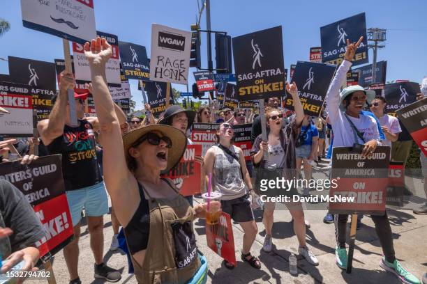 Members of the Hollywood actors SAG-AFTRA union walk a picket line with screenwriters outside of Paramount Studios on Day 2 of the actors' strike on...