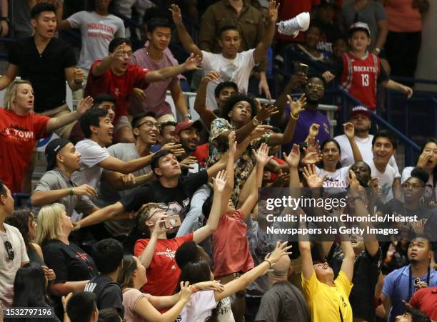 Fans fight to get a James Harden signed and worn game shoe during the NBA game of James Harden charity basketball tournament between Big Tony and La...