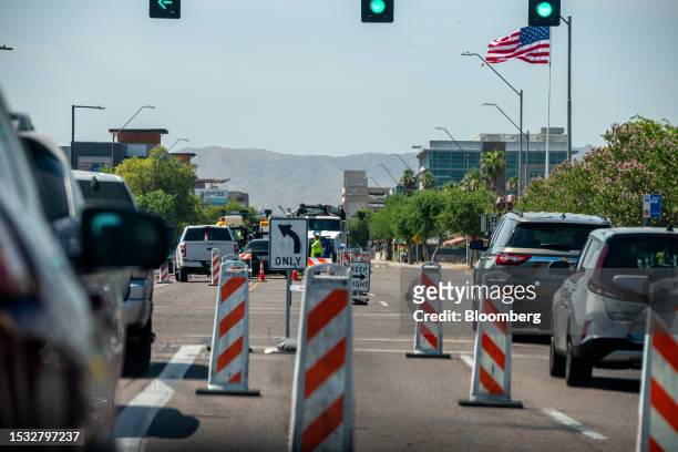 Construction workers pour asphalt during a heatwave in Phoenix, Arizona, US, on Friday, July 14, 2023. Excessive heat warnings and watches are posted...