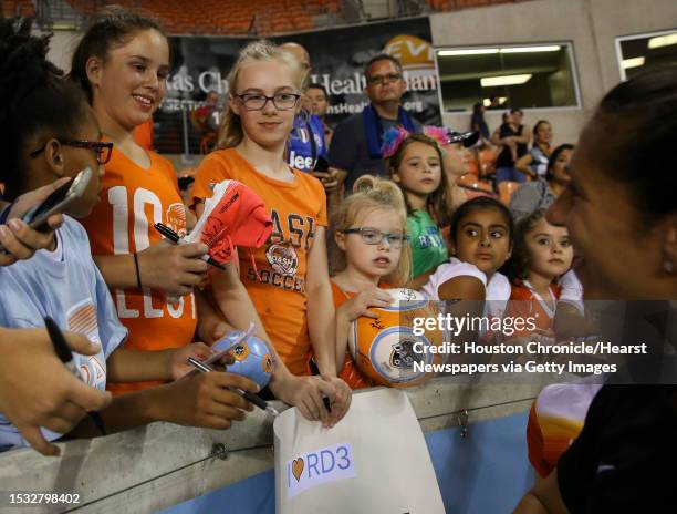 Young Houston Dash fan receives a signed cleat from midfielder Carli Lloyd after the last home game at BBVA Compass Stadium Saturday, Sept. 23 in...