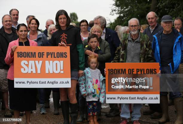 For Witham Priti Patel joins Rosie Pearson founder of Essex Suffolk Norfolk Pylons campaign group and other protesters, holding a sign against the...