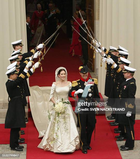Under saluting swords, just married Danish Crown Prince Frederik and his wife Princess Mary Elizabeth Donaldson of Australia leave the Copenhagen...