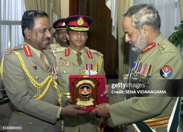 Pakistan's Chairman of the Joint Chiefs of Staff Committee, General Muhammad Aziz Khan is presented with a souvenir by Sri Lankan Army chief...