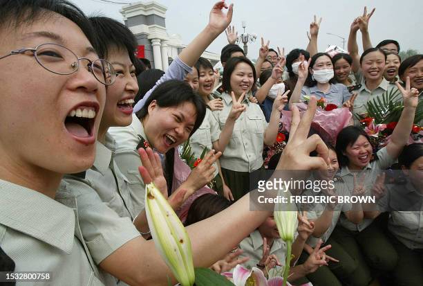 Medical staff from the People's Liberation Army celebrate as they and the last batch of SARS patients are released from the Xiaotangshan SARS...