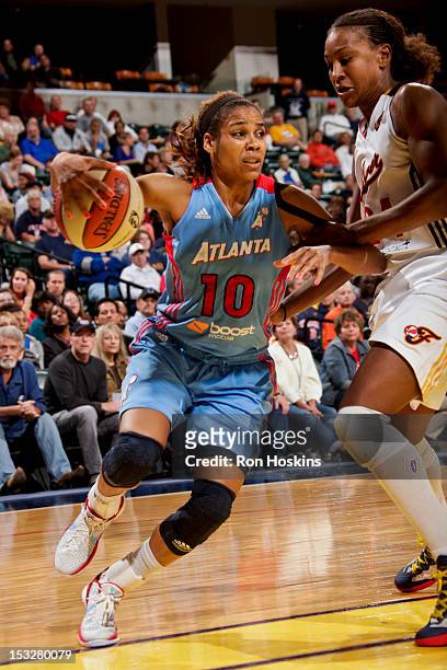 Lindsey Harding of the Atlanta Dream drives against Tamika Catchings of the Indiana Fever in Game Three of the WNBA Eastern Conference Semi-Finals at...