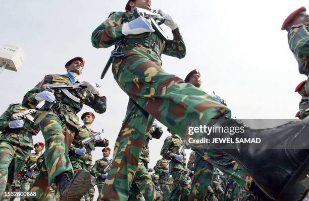 Bangladesh army troops march past saluting President Lajuddin Ahmed during celebrations to mark the country's 33rd Independence Day in Dhaka, 26...