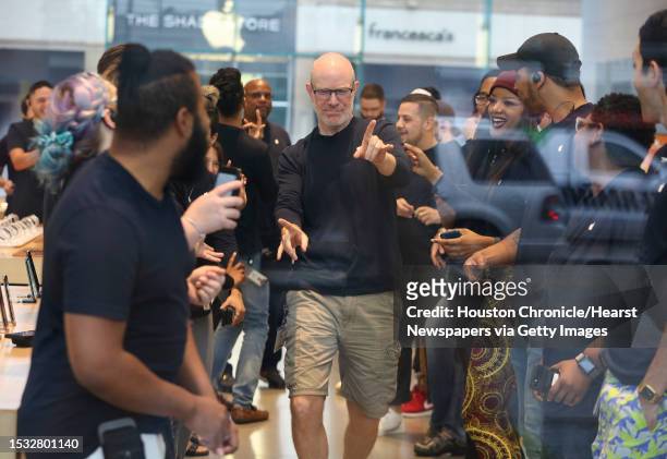 Highland Village Apple store staff rally before open its doors for customers to buy new products on Friday, Sept. 21 in Houston. The newly released...