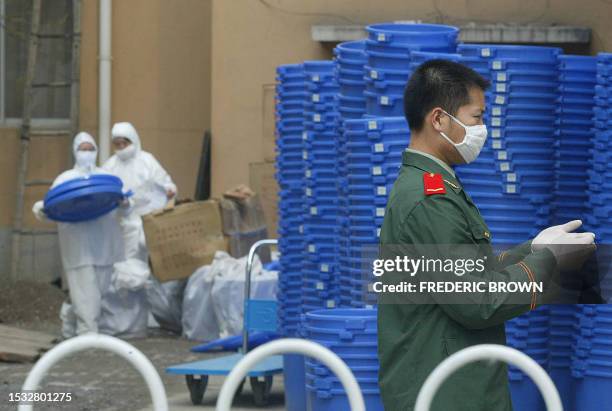 Hospital and military personnel are seen on the grounds of the makeshift SARS facility at Xiaotangshan hospital, 07 May 2003, on the outskirts of...