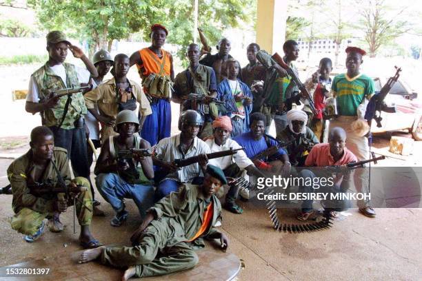 Former rebels, loyalists to Central African Republic new leader Francois Bozize, pose at a checkpoint 21 March 2003 in Bangui. Bozize, who sized the...
