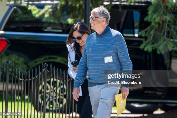 Bill Gates, co-chairman of the Bill and Melinda Gates Foundation, right, walks the grounds during the Allen & Co. Media and Technology Conference in...