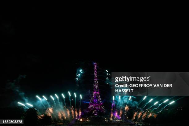 Fireworks explode next to the Eiffel Tower as part of the annual Bastille Day celebrations in Paris, on July 14, 2023.