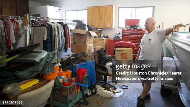James Besch watches the rack of clothes he saved during Hurricane Harvey and hasn't had a chance to put them back to his house in the Castlewood...
