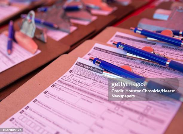 Texas voter registration application forms are waiting for people to register during a voter registration drive hosted by the Houston Rockets Friday,...