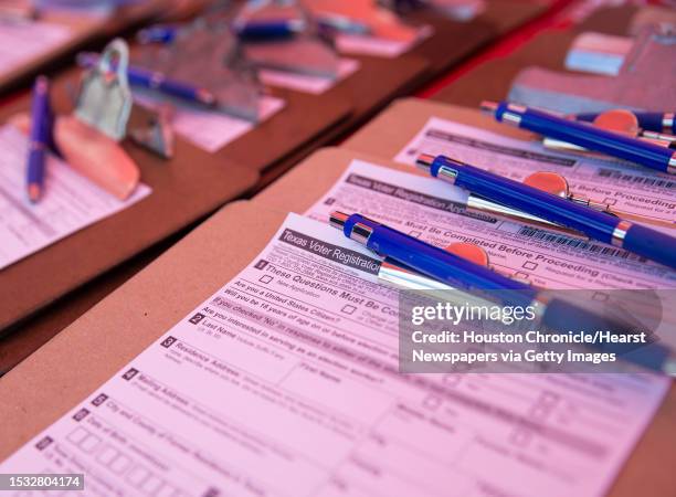 Texas voter registration application forms are waiting for people to register during a voter registration drive hosted by the Houston Rockets Friday,...