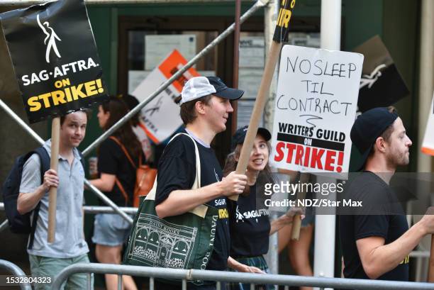 Paul Dano and Zoe Kazan are seen walking the picket line with striking WGA and SAG-AFTRA members on July 14, 2023 in New York City.