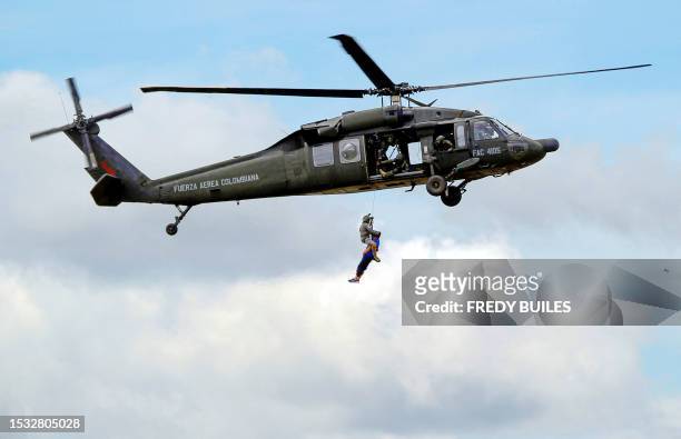 Members of the Colombian Air Force pilots perform a rescue operation with a Sikorsky UH-60 Black Hawk helicopter during the F-Air Colombia 2023 air...