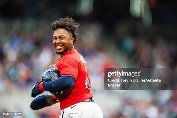 Ozzie Albies of the Atlanta Braves smiles as he runs back to second during the first inning against the Chicago White Sox at Truist Park on July 14,...