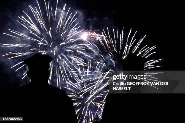 Sailors watch fireworks explode near the Eiffel Tower as part of the annual Bastille Day celebrations in Paris, on July 14, 2023.