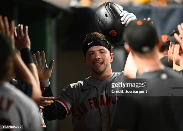 Patrick Bailey of the San Francisco Giants celebrates with teammates after scoring during the seventh inning against the Pittsburgh Pirates at PNC...