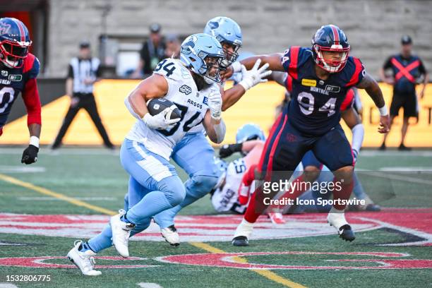 Toronto Argonauts running back AJ Ouellette runs the ball during the Toronto Argonauts versus the Montreal Alouettes game on July 14 at Percival...