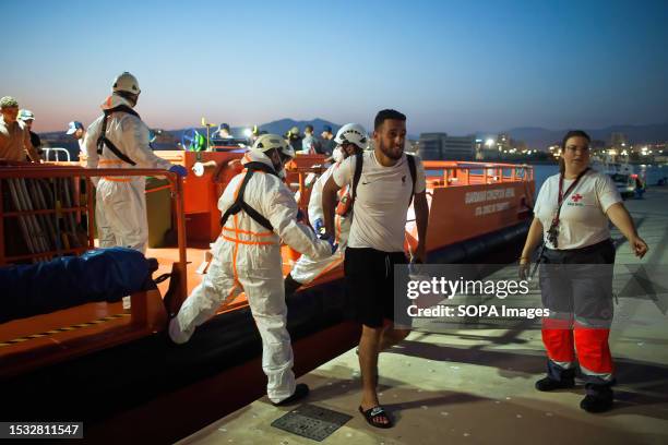 Migrant, who was rescued from a dinghy in the Mediterranean Sea, is seen disembarking from a Spanish rescue boat after his arrival at Port of Malaga....