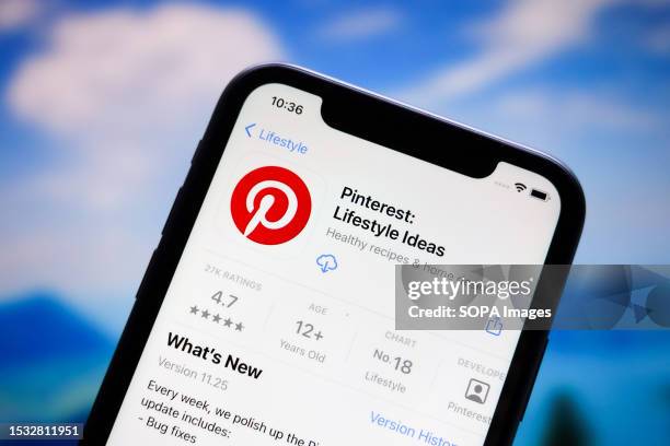 In this photo illustration, the Pinterest app logo is displayed in the Apple Store for iphones.