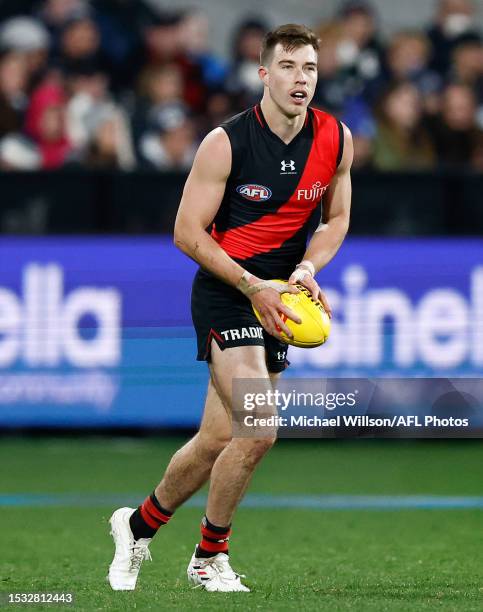 Zach Merrett of the Bombers in action during the 2023 AFL Round 18 match between the Geelong Cats and the Essendon Bombers at GMHBA Stadium on July...