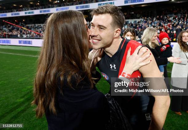 Zach Merrett of the Bombers is seen with partner Alex Bourne before his 200th match during the 2023 AFL Round 18 match between the Geelong Cats and...