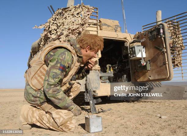 Prince Harry eats a breakfast of biscuits mixed with jam and butter in the desert in Helmand province in Southern Afghanistan, on February 19, 2008s....