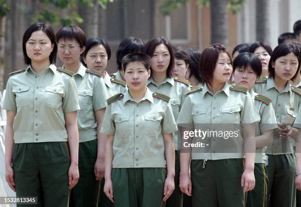 Chinese People's Liberation Army nurses file in to prepare to staff the hospital erected in barely a week to house a rapidly increasing number of...