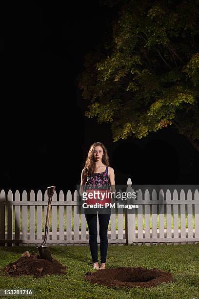 young woman about to bury box - digging hole stock pictures, royalty-free photos & images