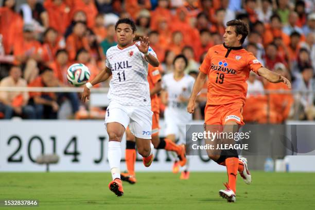 Davi of Kashima Antlers and Dejan Jakovic of Shimizu S-Pulse compete for the ball during the J.League J1 match between Shimizu S-Pulse and Kashima...