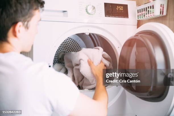 man using dryer - trockner stock-fotos und bilder